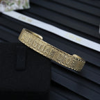 Dior gold-tone cuff bracelet with textured band and slim hinge bar