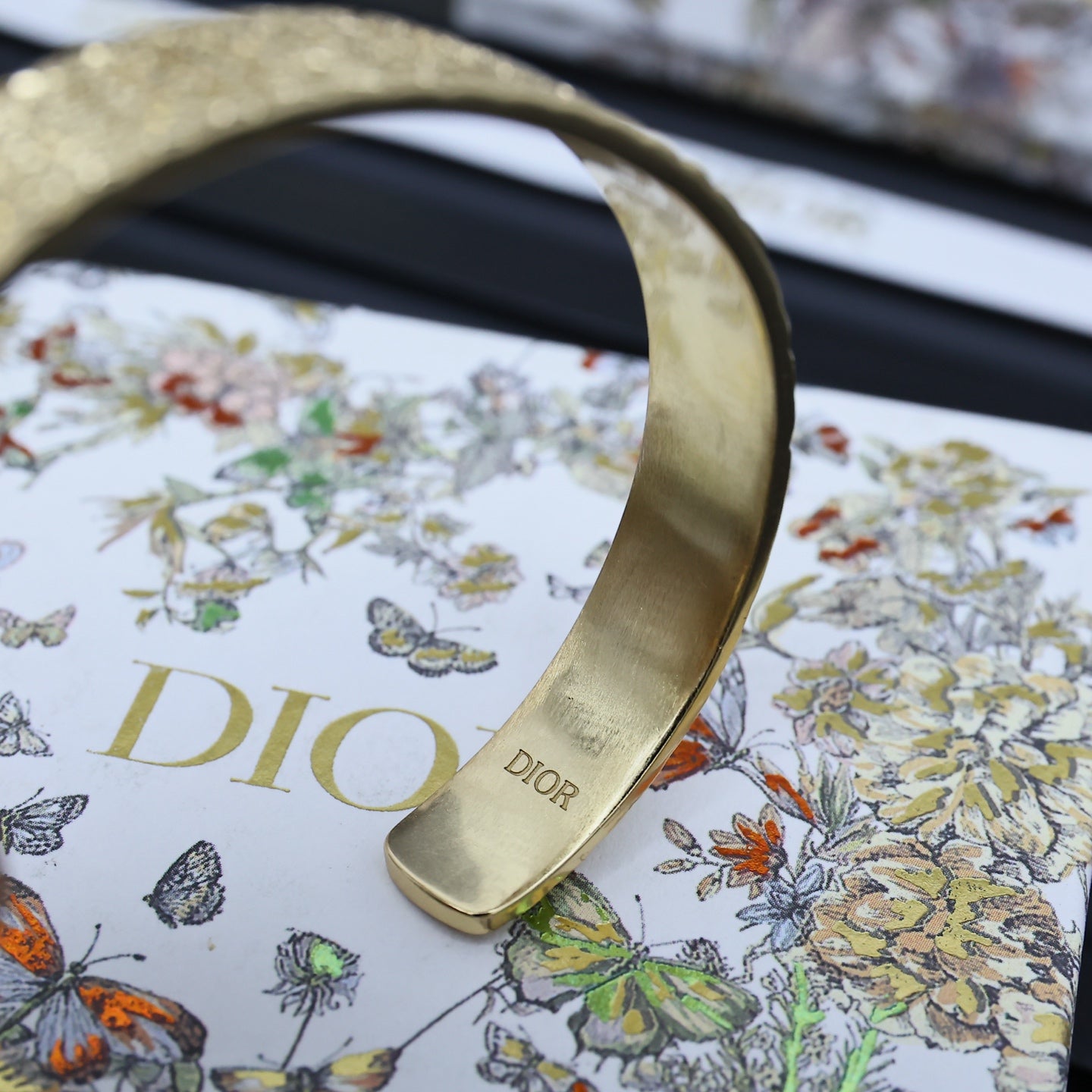 Dior gold-tone cuff bracelet with engraved DIOR lettering on the inside