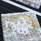 Dior gold-tone cuff bracelet with engraved logo and arched open edge