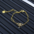 Gold-tone chain bracelet with small charm and round pendant detail