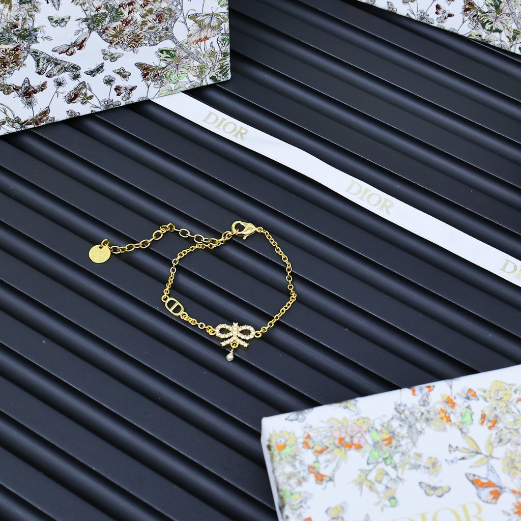 Gold-tone charm bracelet on Dior gift card set