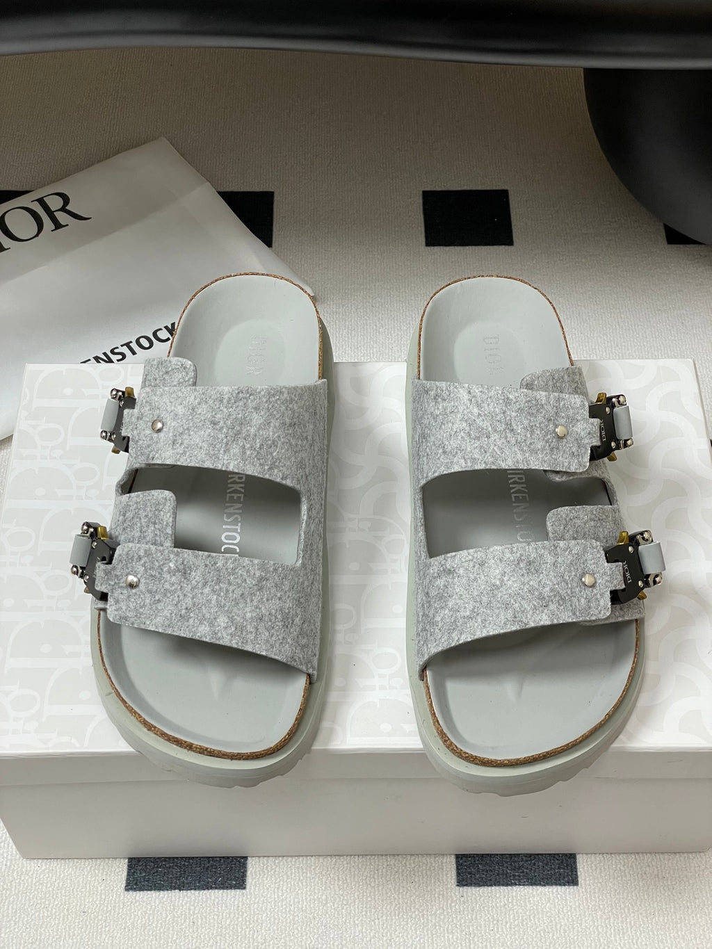 Grey Dior sandals with double wide strap, gold buckle hardware and stud accents