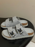 Grey Dior sandals with textured upper, adjustable buckle straps, and cushioned sole