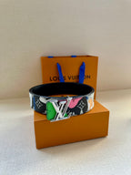 Louis Vuitton belt with black base strap and multicolor graphic panel plus gold LV buckle