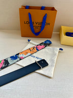 Louis Vuitton belt long strap with colorful print and gold LV buckle near accessories