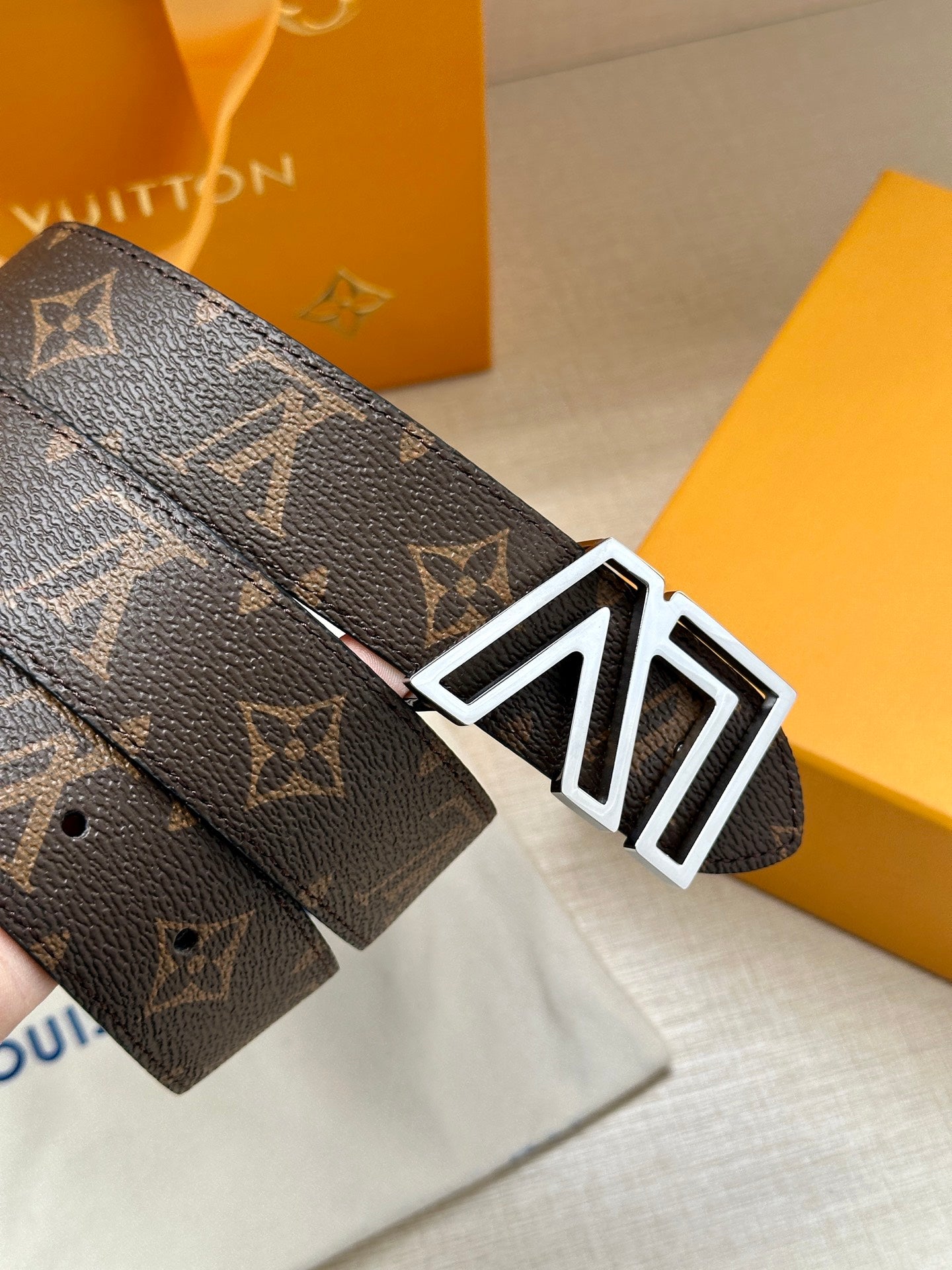 Louis Vuitton monogram belt with LV silver buckle on dark brown leather