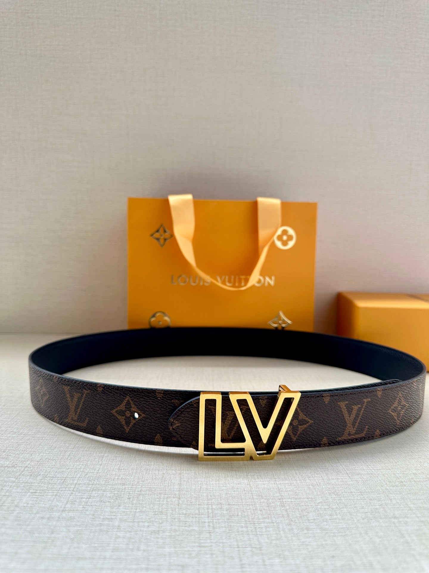 Louis Vuitton monogram belt with LV gold buckle on dark brown strap