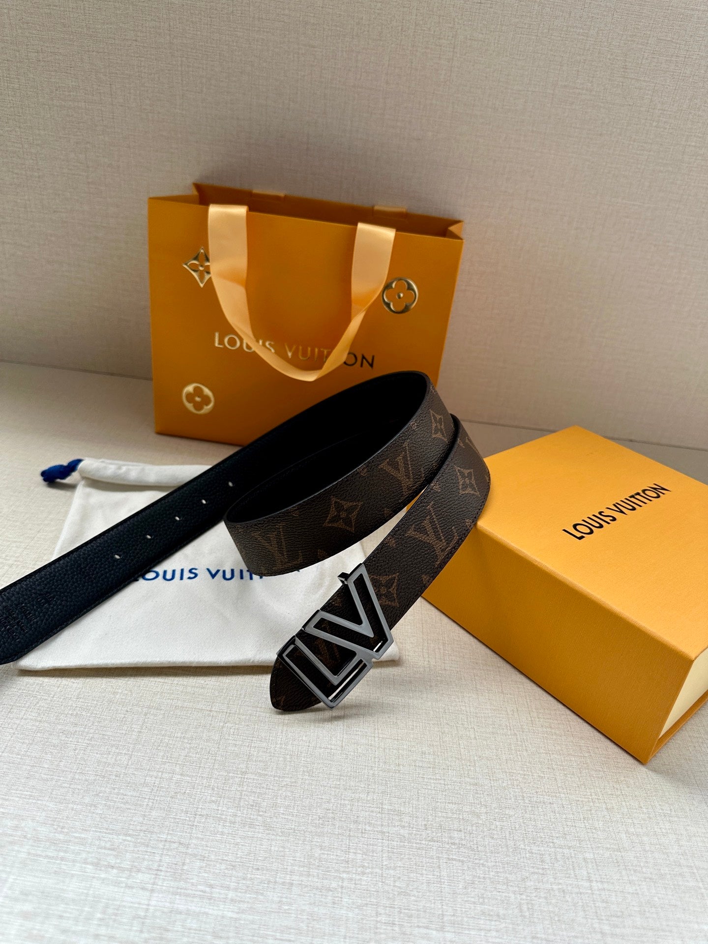 Louis Vuitton belt with LV silver buckle on dark monogram strap