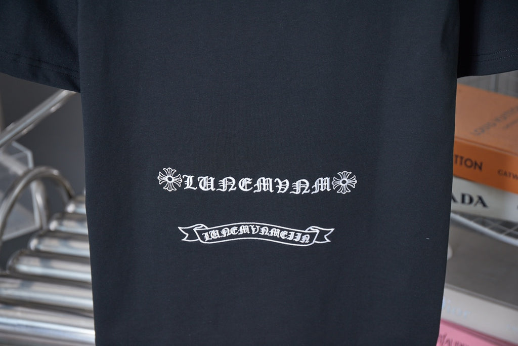 Black T-shirt with white line emblem and decorative text on the back