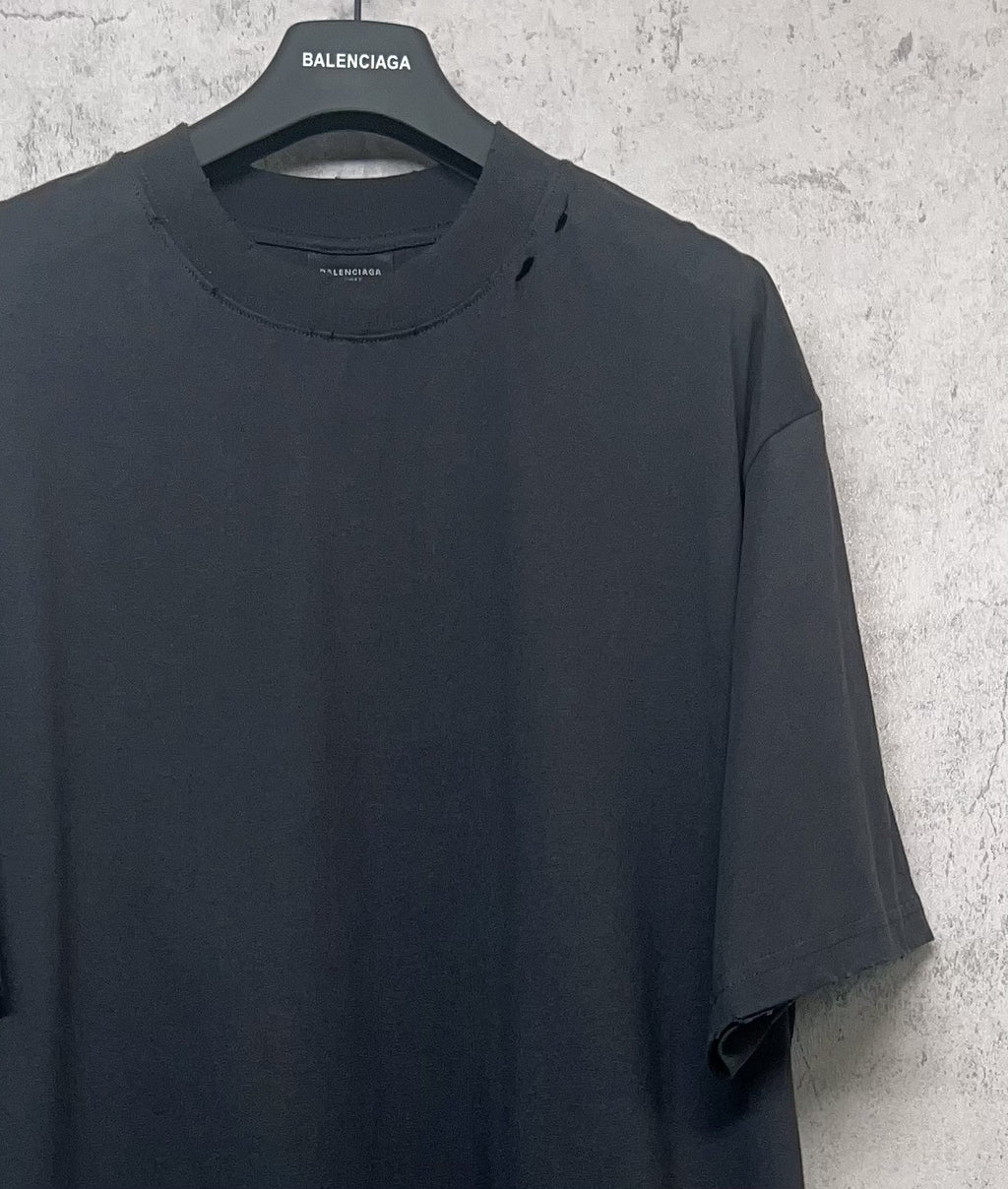 Balenciaga dark crew-neck T-shirt upper front close-up