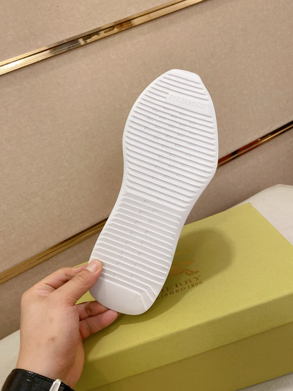 White rubber outsole of a low-top sneaker with textured tread pattern.