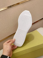 White rubber outsole of a low-top sneaker with textured tread pattern.