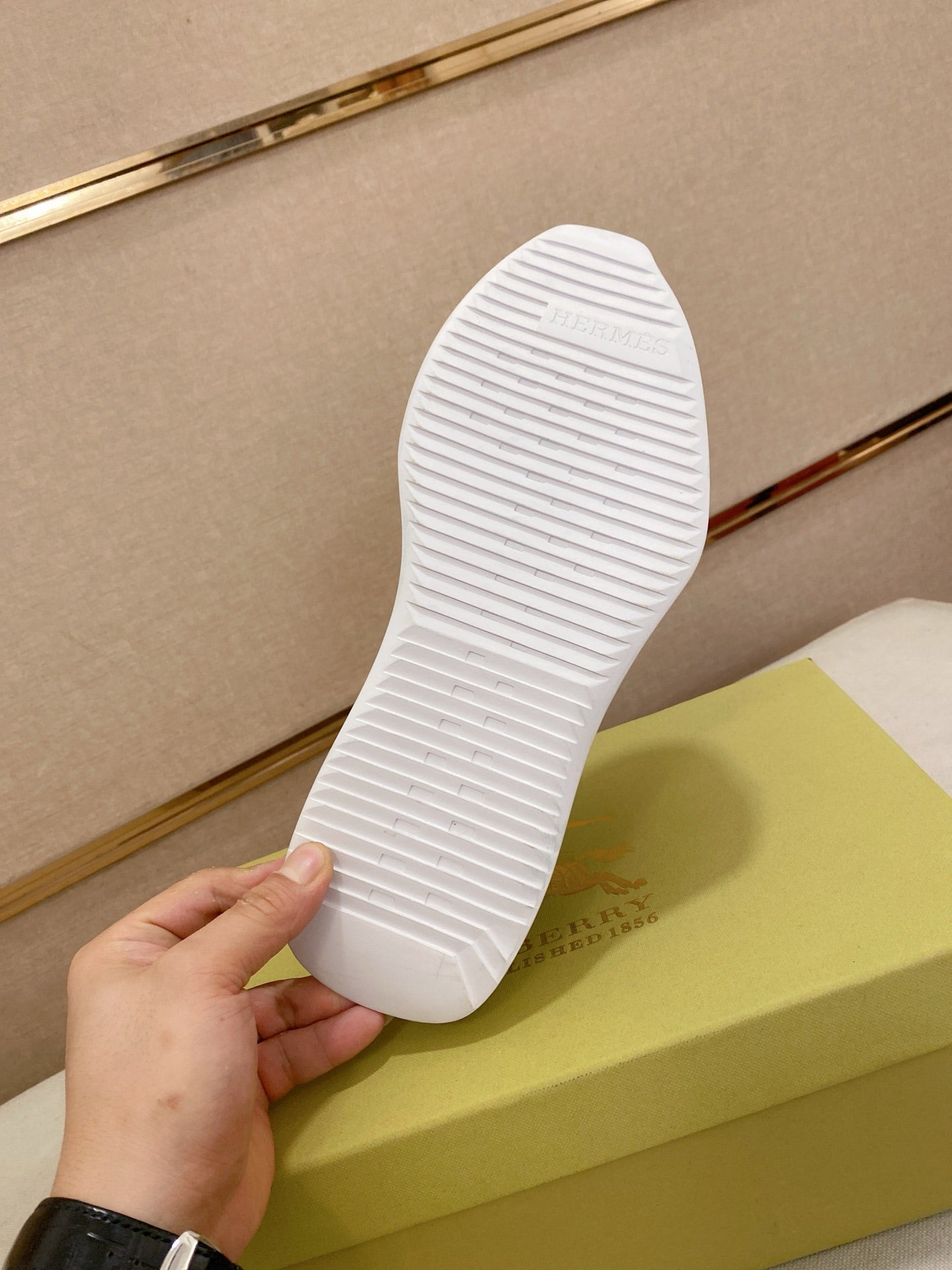 White rubber outsole of a low-top sneaker with textured tread pattern.