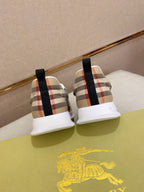 Back view of plaid canvas sneakers with black heel tabs and white soles.