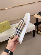 Plaid canvas low-top sneaker with white sidewalls, lace-up eyelets, and rubber sole.