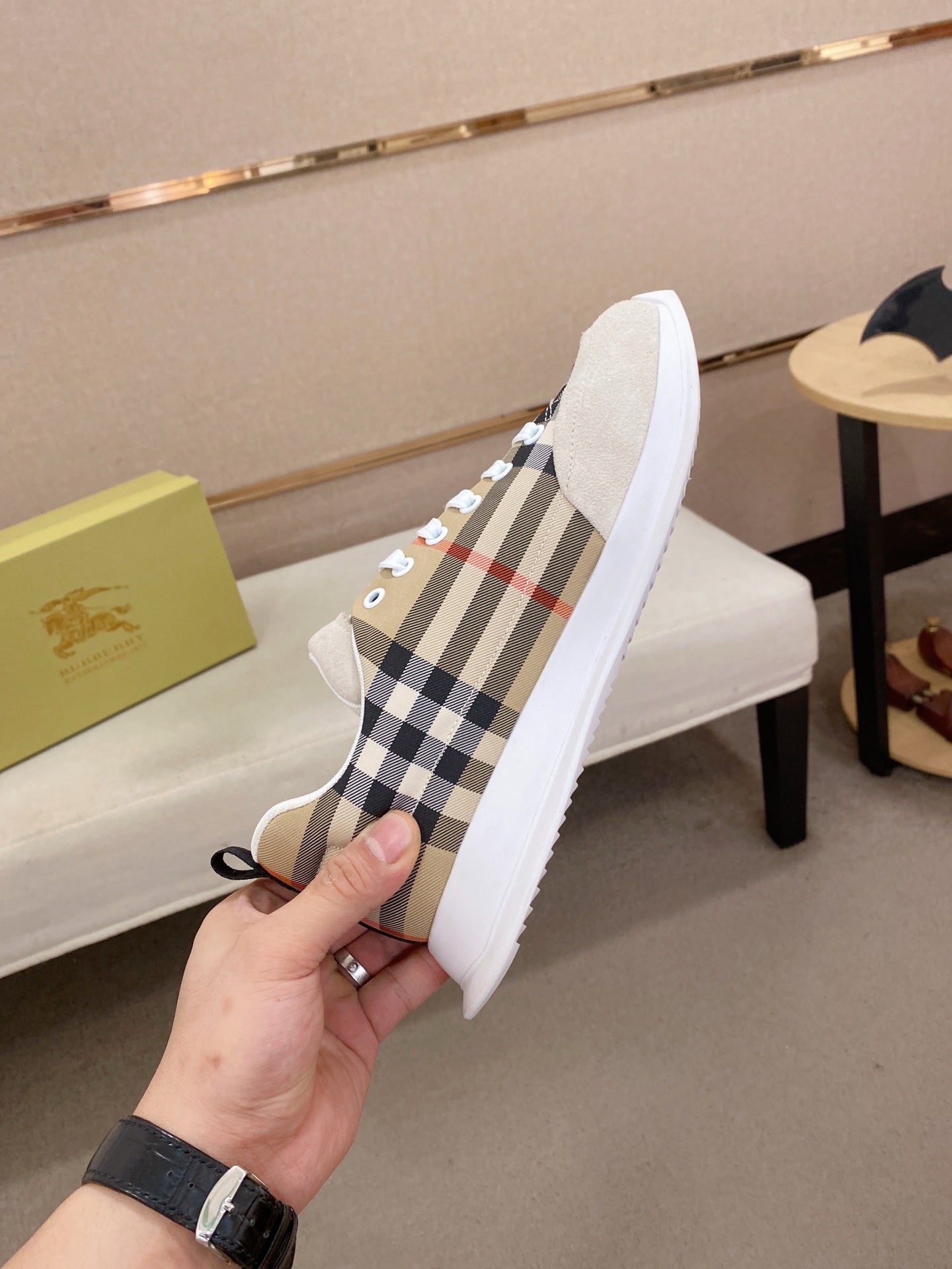 Plaid canvas low-top sneaker with white sidewalls, lace-up eyelets, and rubber sole.