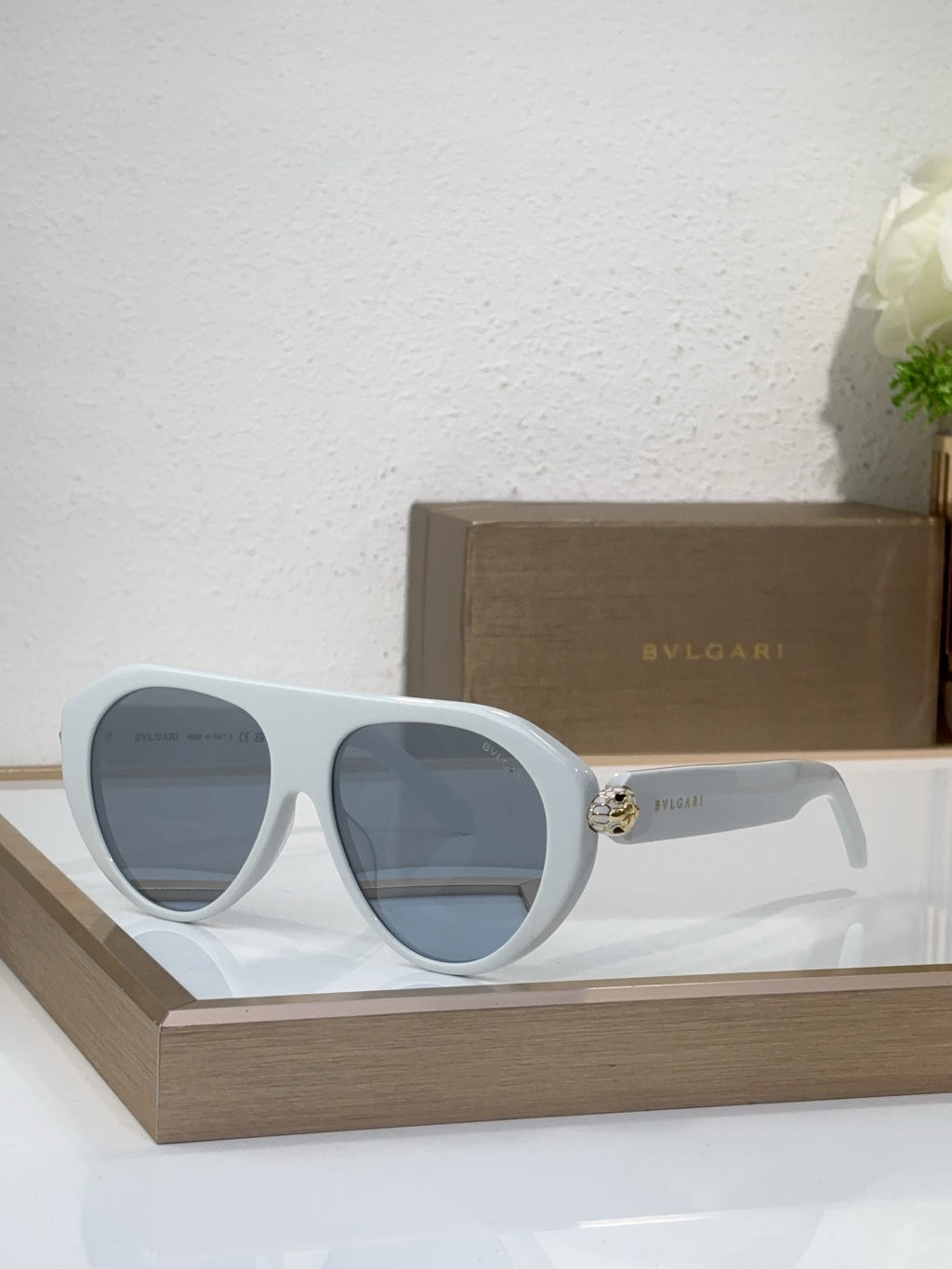 Bvlgari sunglasses with white frames and blue mirrored lenses, round cat-eye style