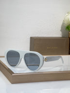 Bvlgari sunglasses with white frames and blue mirrored lenses, round cat-eye style