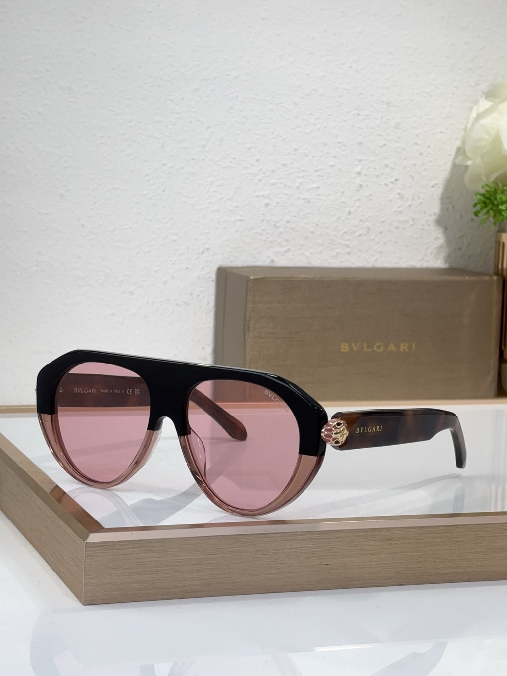 Bvlgari sunglasses with black frames and pink mirrored lenses, round cat-eye style