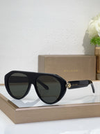 Bvlgari sunglasses with black frames and dark mirrored lenses, round cat-eye style
