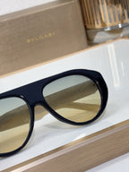 Bvlgari sunglasses with navy frames and gradient lenses, close side profile