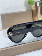 Bvlgari sunglasses with navy frames and dark green lenses, side view with logo detail