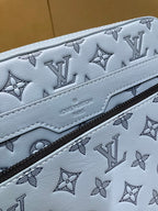 Light blue monogram crossbody bag detail with patterned leather and contrast stitching