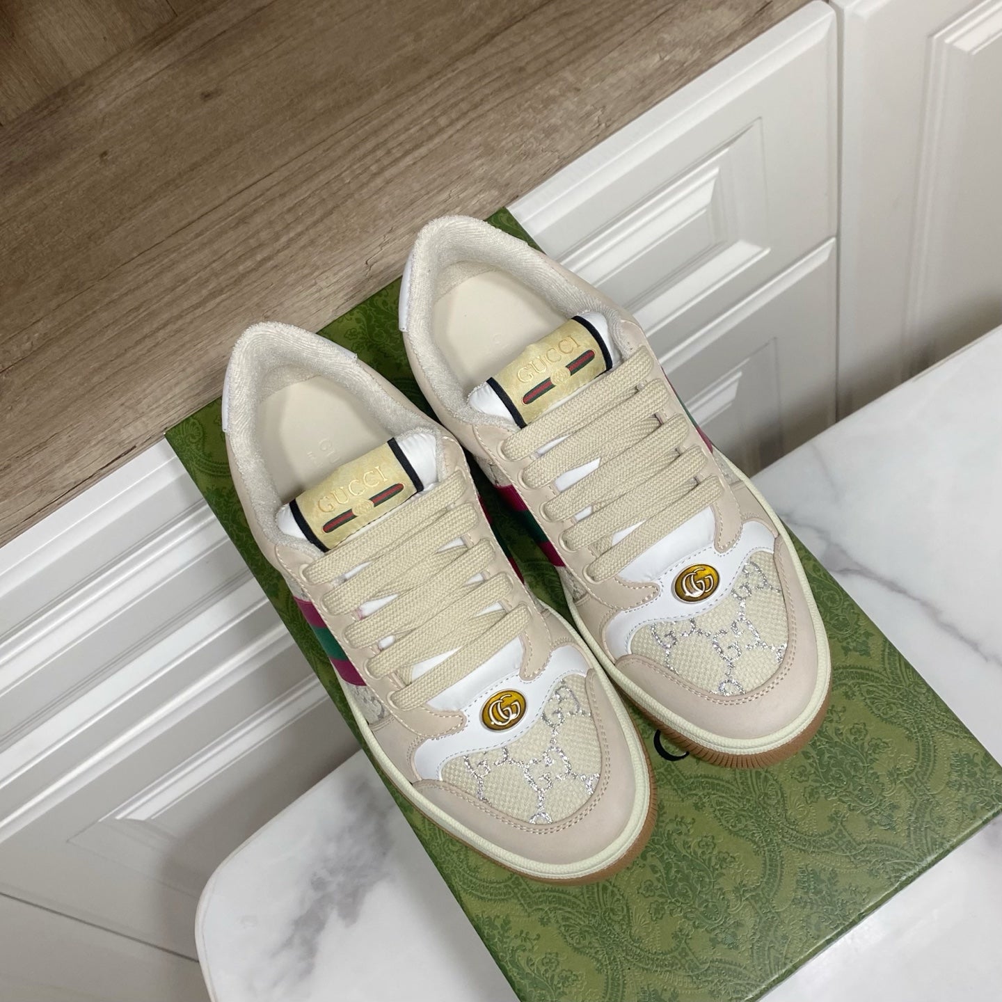 Cream Gucci unisex sneakers with lace-up front and multicolor stripe, pair view