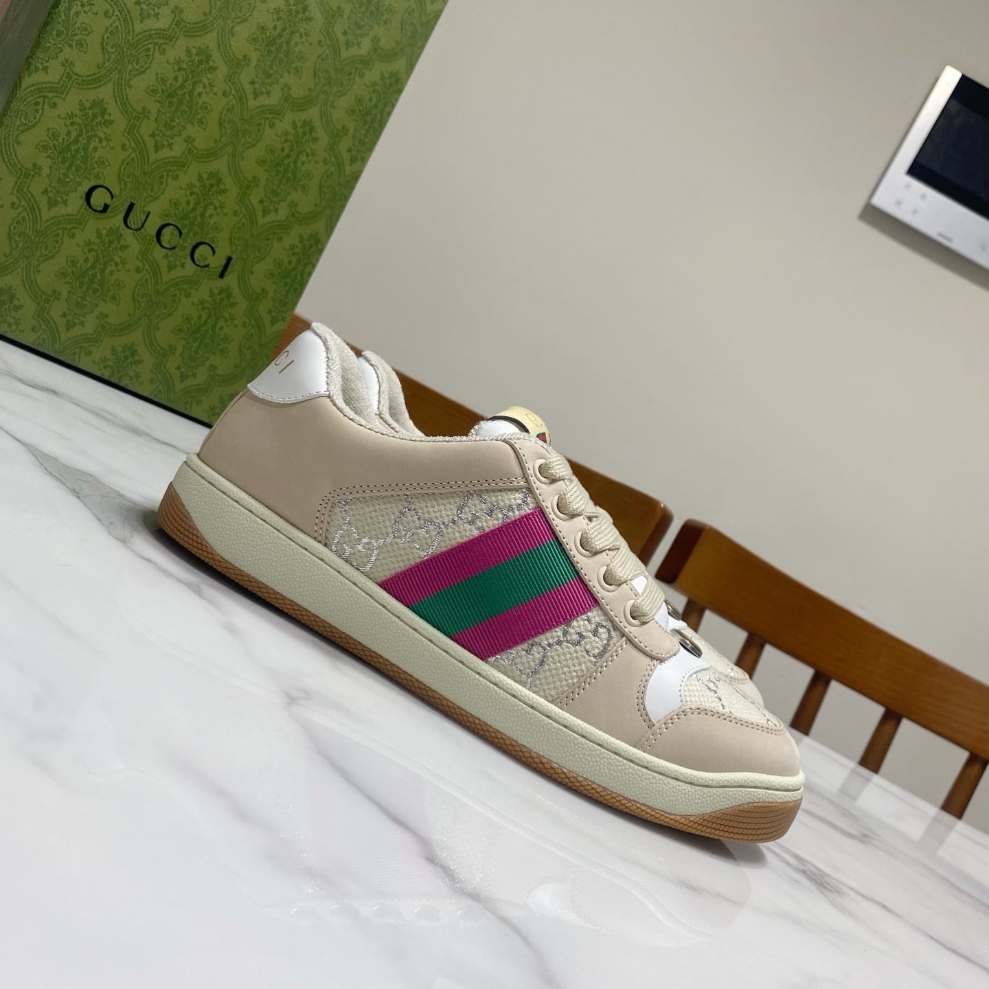 Beige Gucci unisex sneaker, side view with magenta and green striped panel