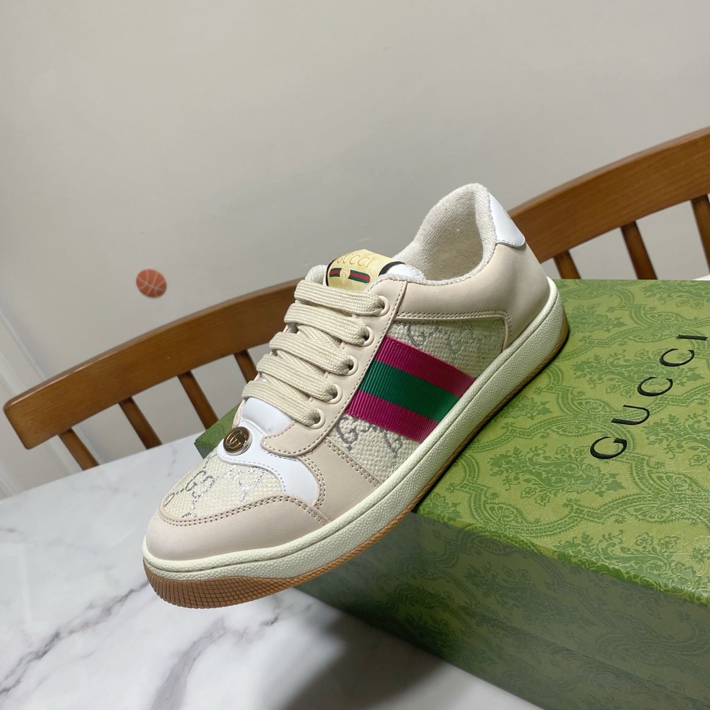 Cream Gucci unisex sneaker profile with magenta-green stripe and lace-up front