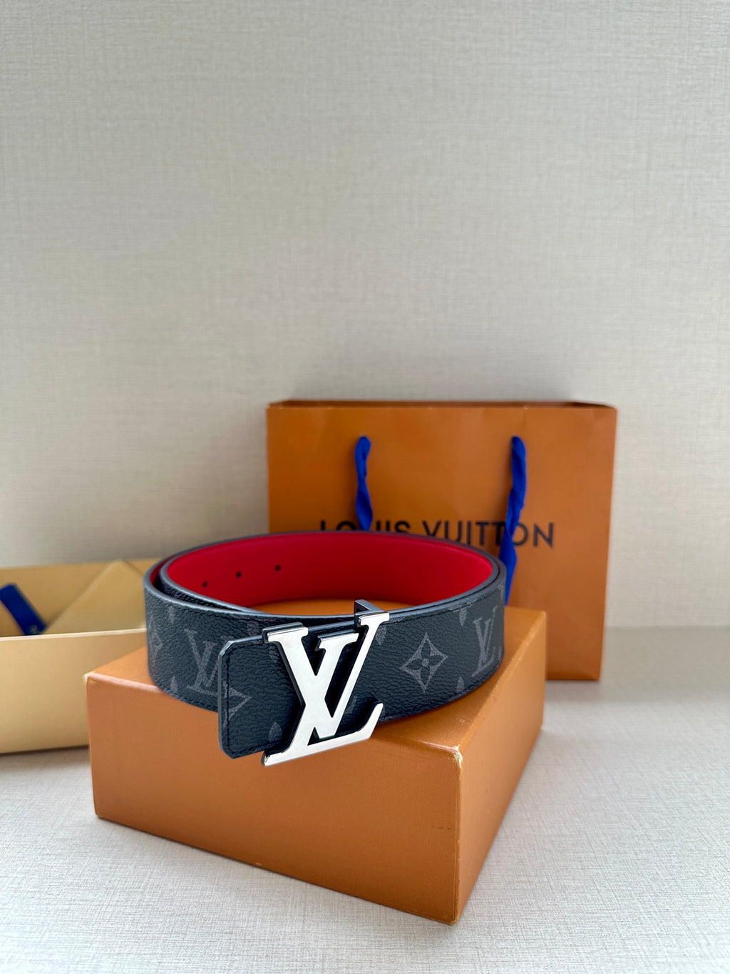 Navy monogram leather belt with gold LV buckle and red interior