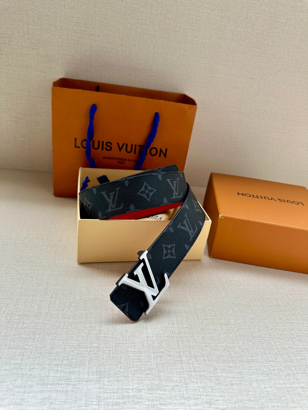 Navy monogram leather belt with gold LV buckle and red inner strap