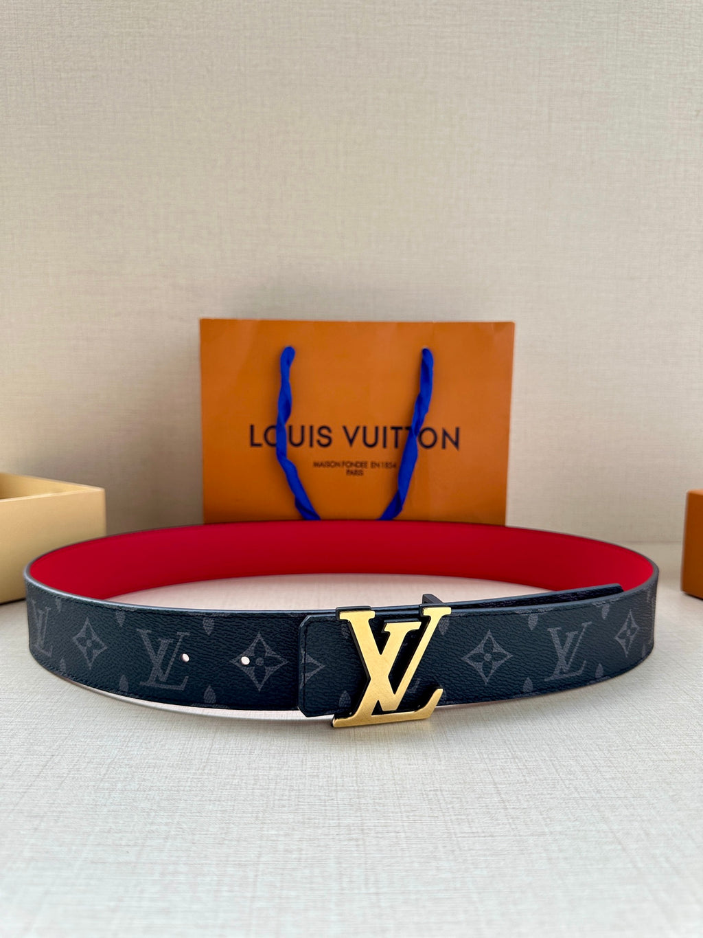 Navy monogram leather belt with gold LV buckle and red underside