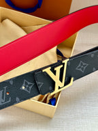 Navy monogram belt close-up with gold LV buckle and red-lined leather