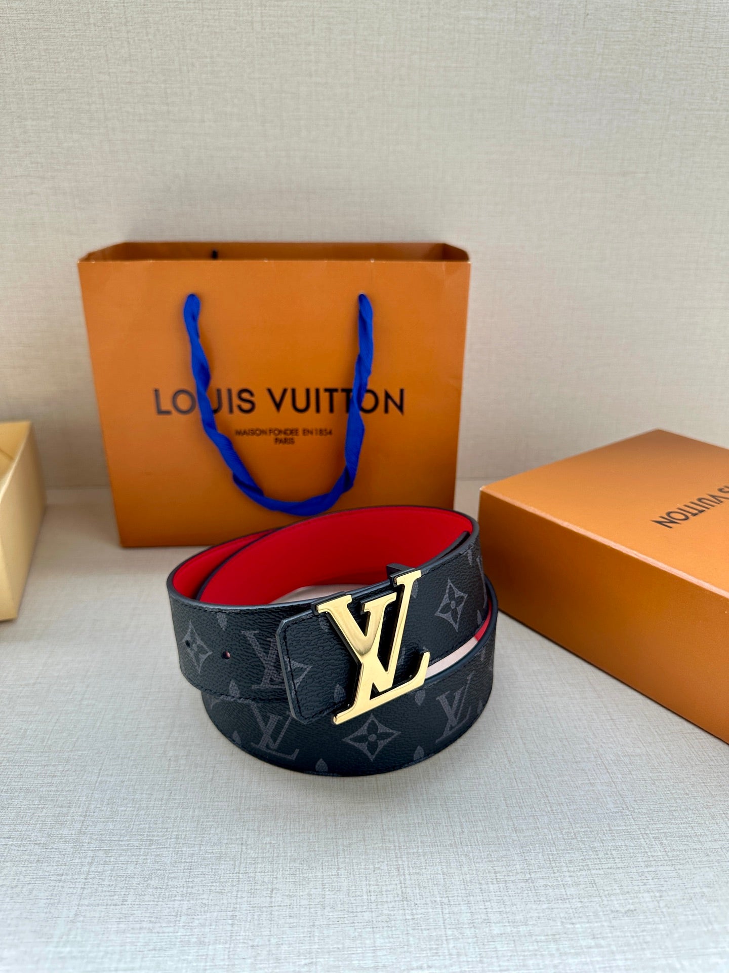 Navy monogram leather belt with gold LV buckle and red inner strap
