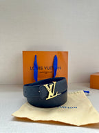 Blue embossed leather belt with gold-tone LV logo buckle, on light cloth.