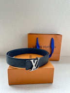 Blue embossed leather belt with silver LV logo buckle on display.