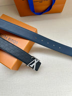 Blue embossed leather belt with silver prong buckle and punched adjustment holes.