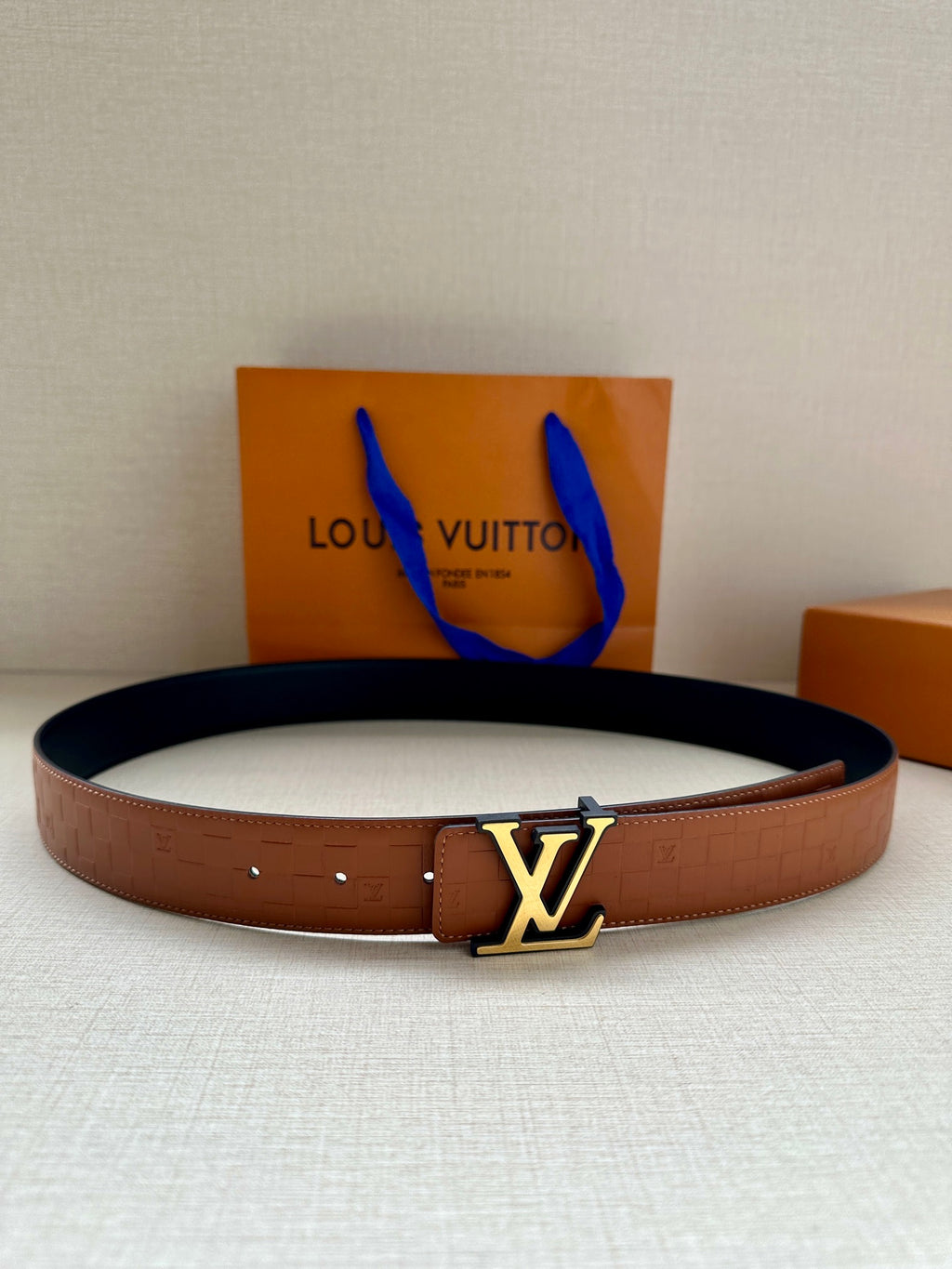 Louis Vuitton leather belt in dark brown with gold-tone LV buckle