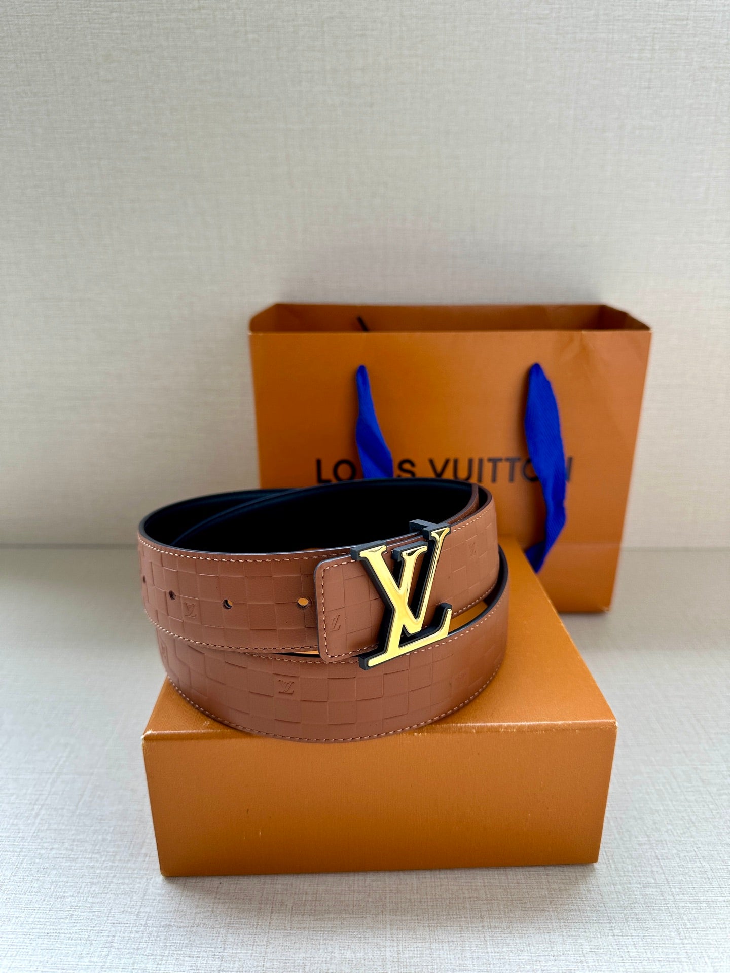 Louis Vuitton embossed tan leather belt with gold-tone LV buckle