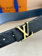 Louis Vuitton belt close-up: embossed dark blue strap with gold LV buckle