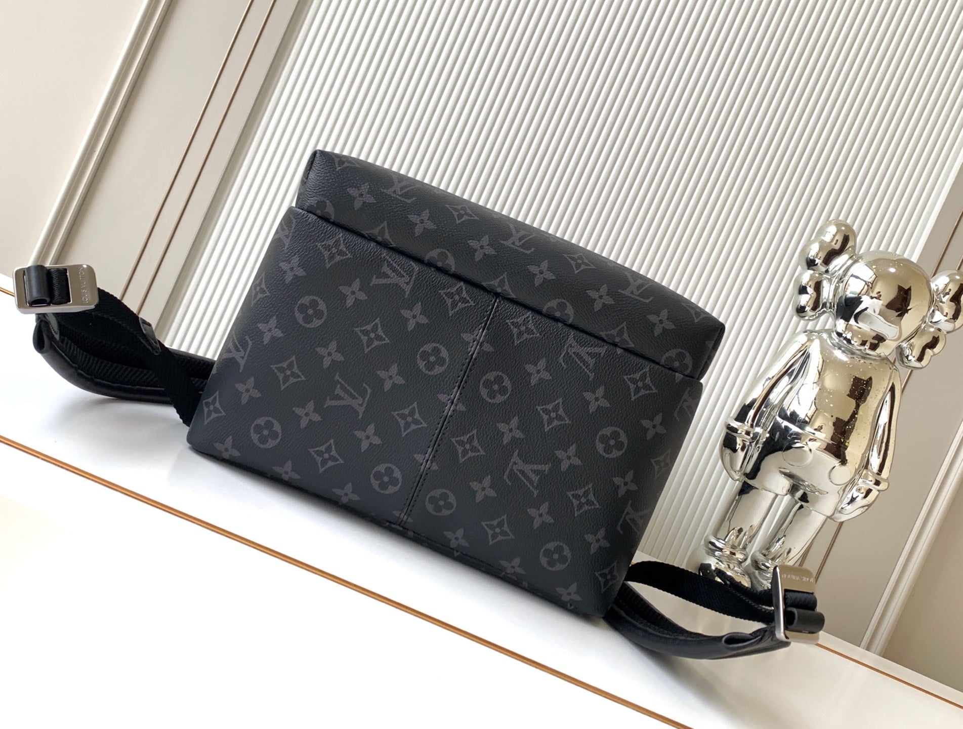 Men's designer monogram crossbody-style backpack with long strap and flap