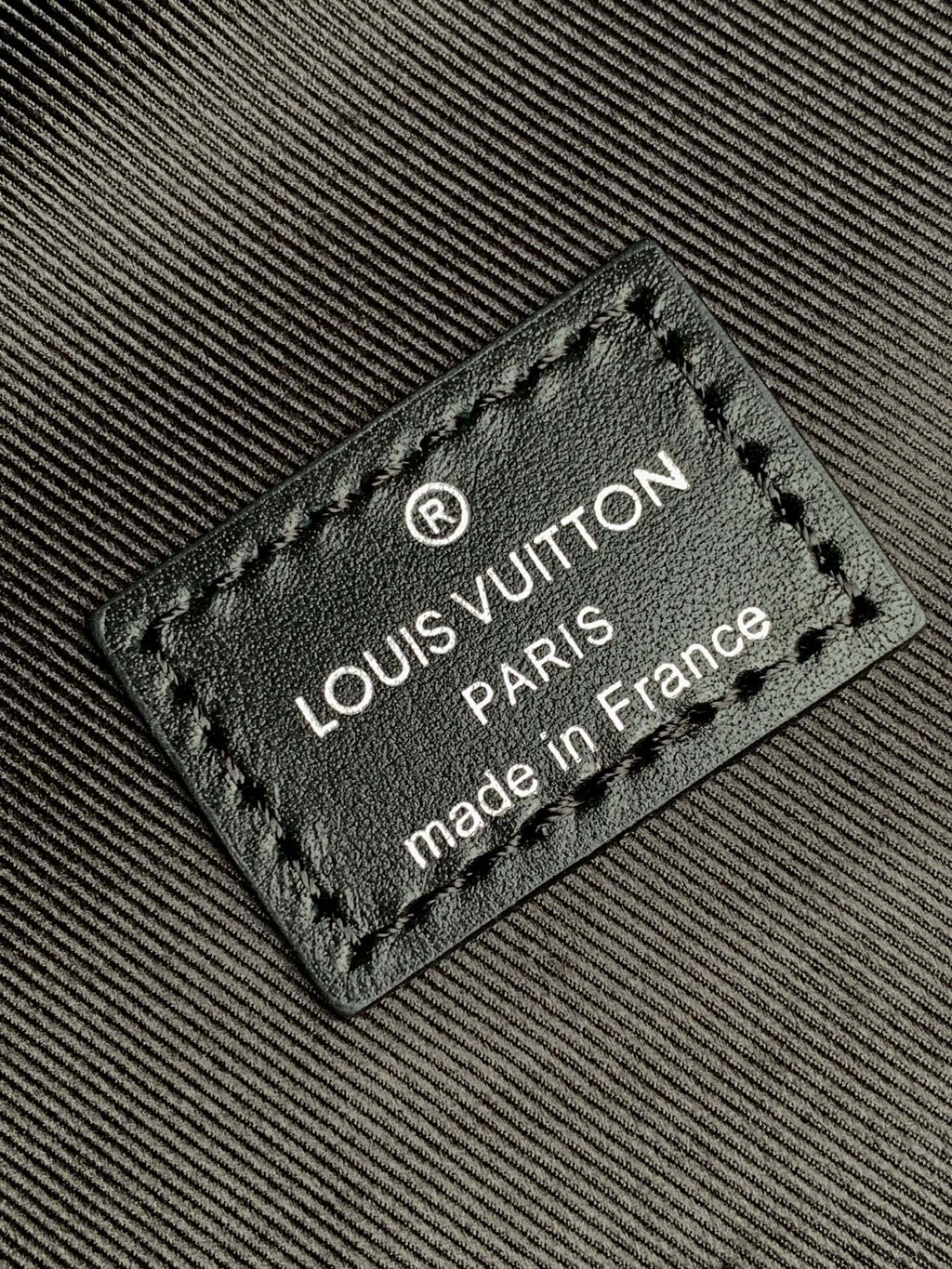 Louis Vuitton made in France label on dark monogram backpack