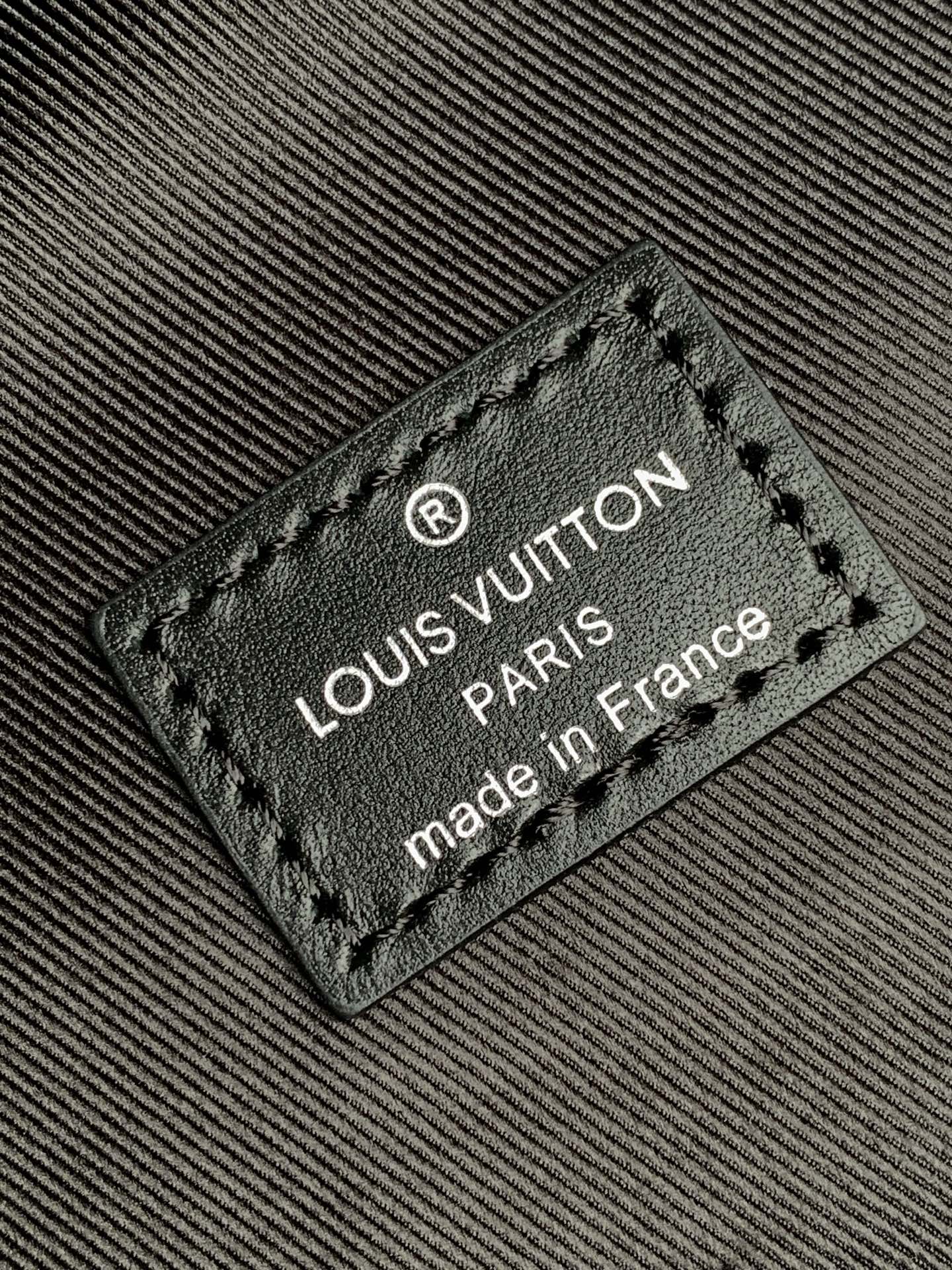 Louis Vuitton made in France label on dark monogram backpack