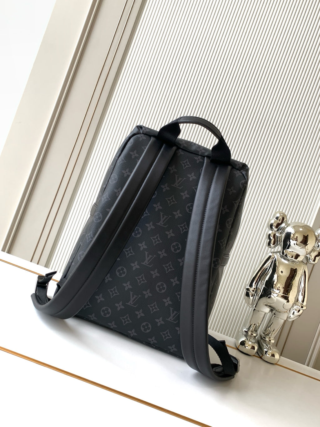 Men's designer monogram backpack with side panels and adjustable shoulder straps