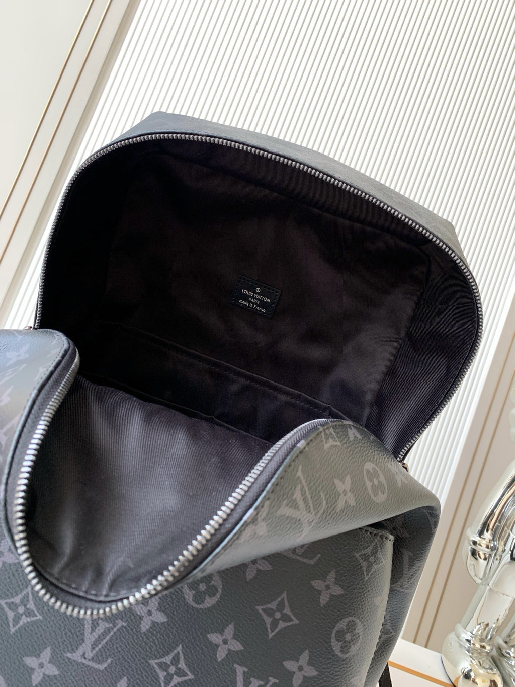 Men's monogram backpack open view with inner lining and zipper top