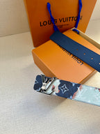 Louis Vuitton belt with blue monogram strap and gold-tone buckle on metal plates.