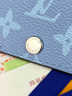 Blue small bag with round metal logo snap closure
