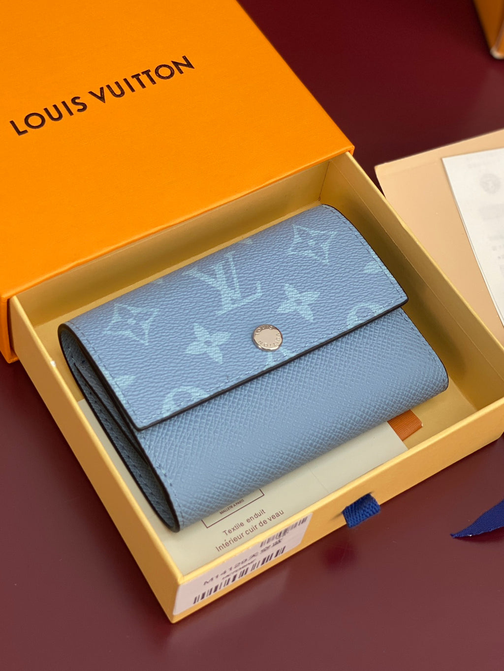 Light blue Louis Vuitton small bag with monogram flap and gold snap button detail