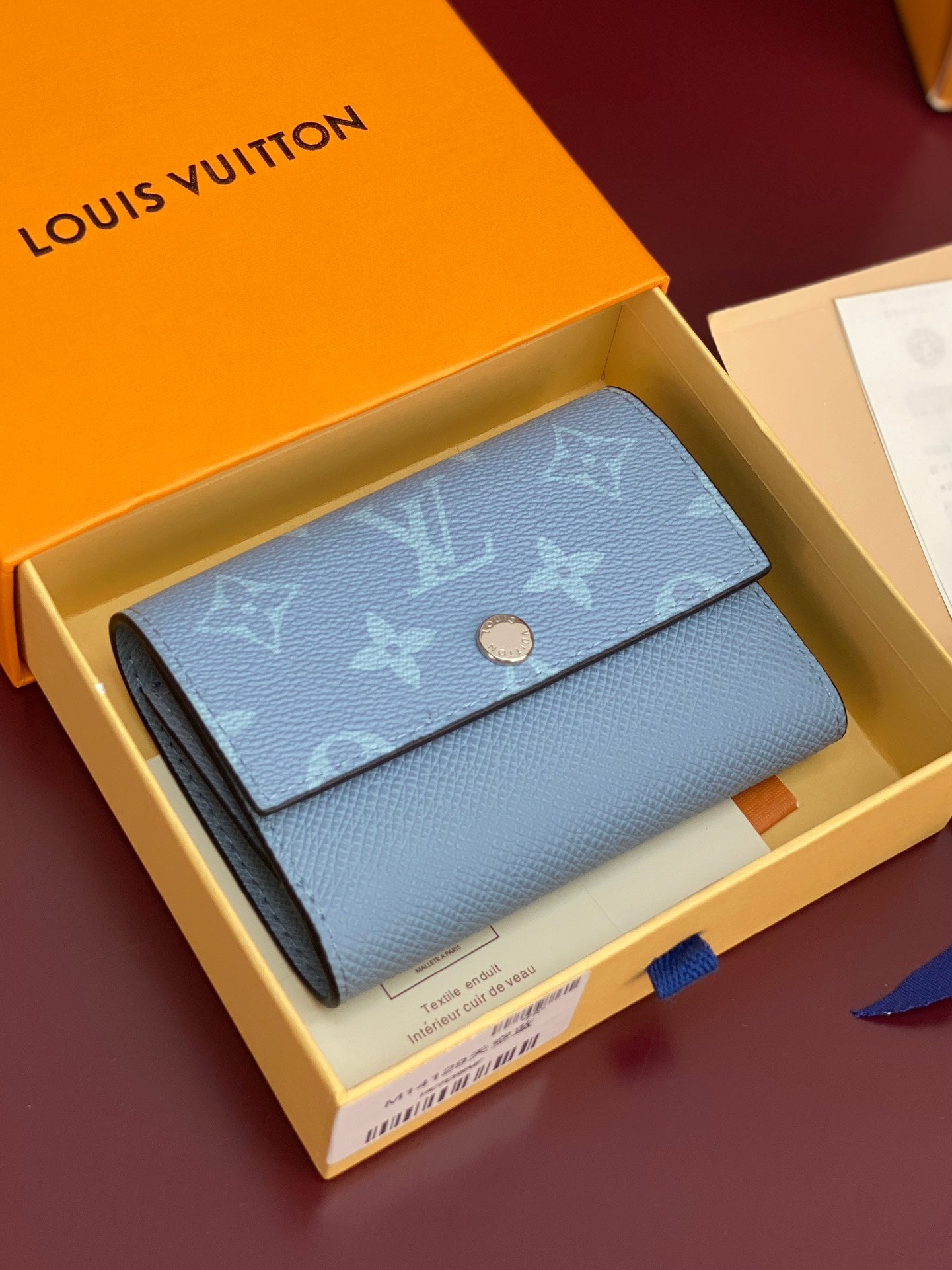 Light blue Louis Vuitton small bag with monogram flap and gold snap button detail